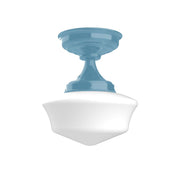 Light blue flush mount ceiling light with bell-shaped white glass shade