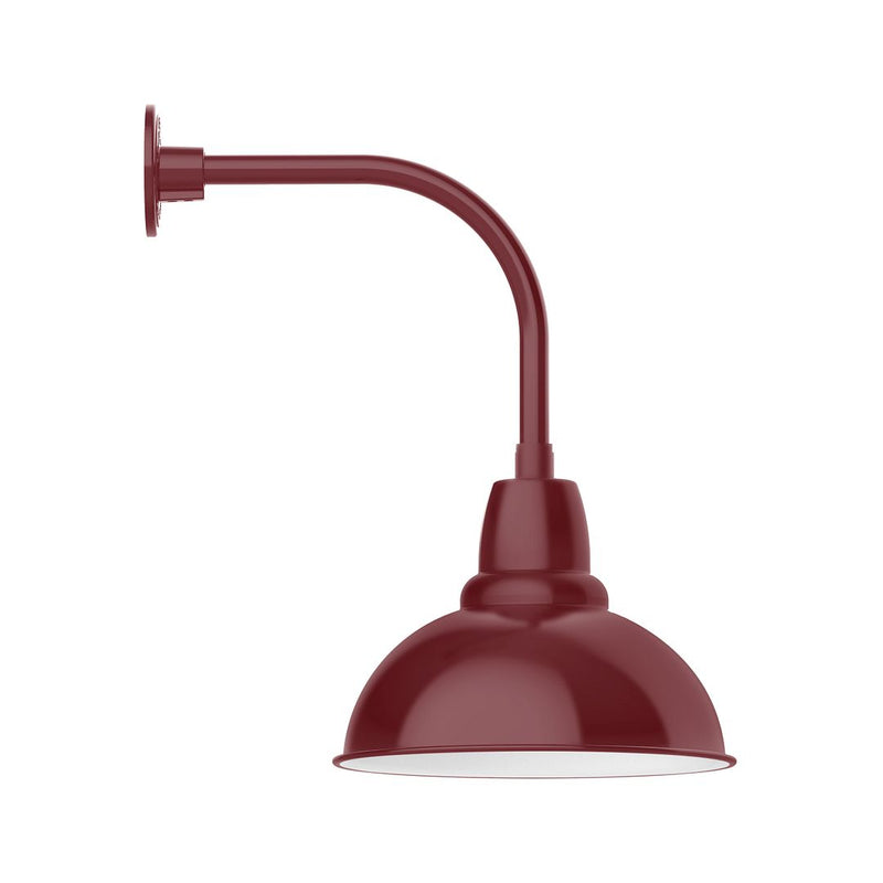 Barn red curved-arm wall light with dome shade, mounted on round backplate.