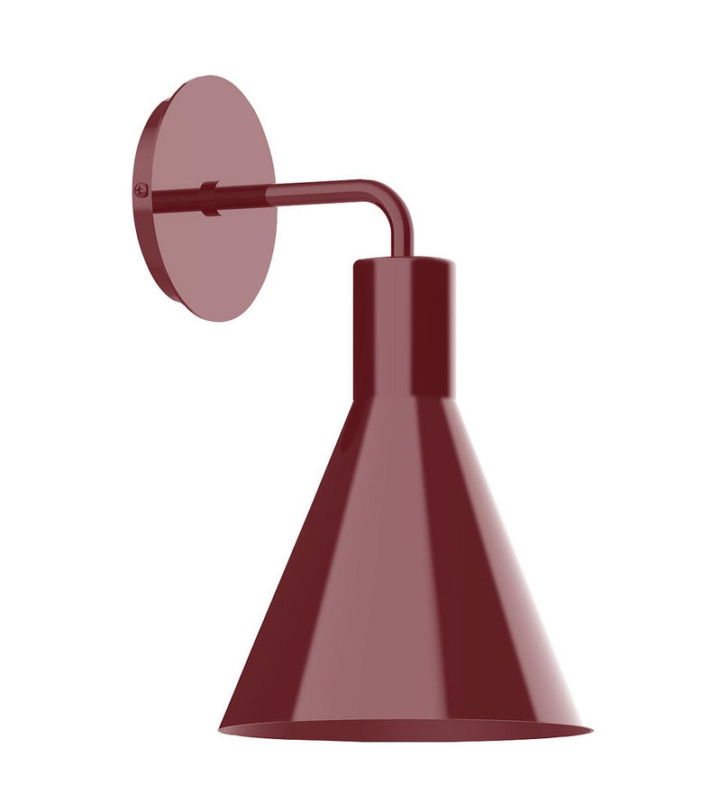 Barn red wall sconce with round backplate, curved arm, and bell-shaped shade