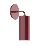 Barn red wall sconce with round backplate and cylindrical shade on curved arm