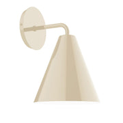 Cream wall sconce with round backplate, curved arm, and cone shade