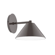 Architectural wall sconce with round backplate, long arm, and conical shade in bronze