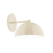 Cream dome wall sconce with curved arm and round shade, 8-inch size.