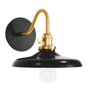 Black wall sconce with brushed brass gooseneck, round backplate, and black dome shade