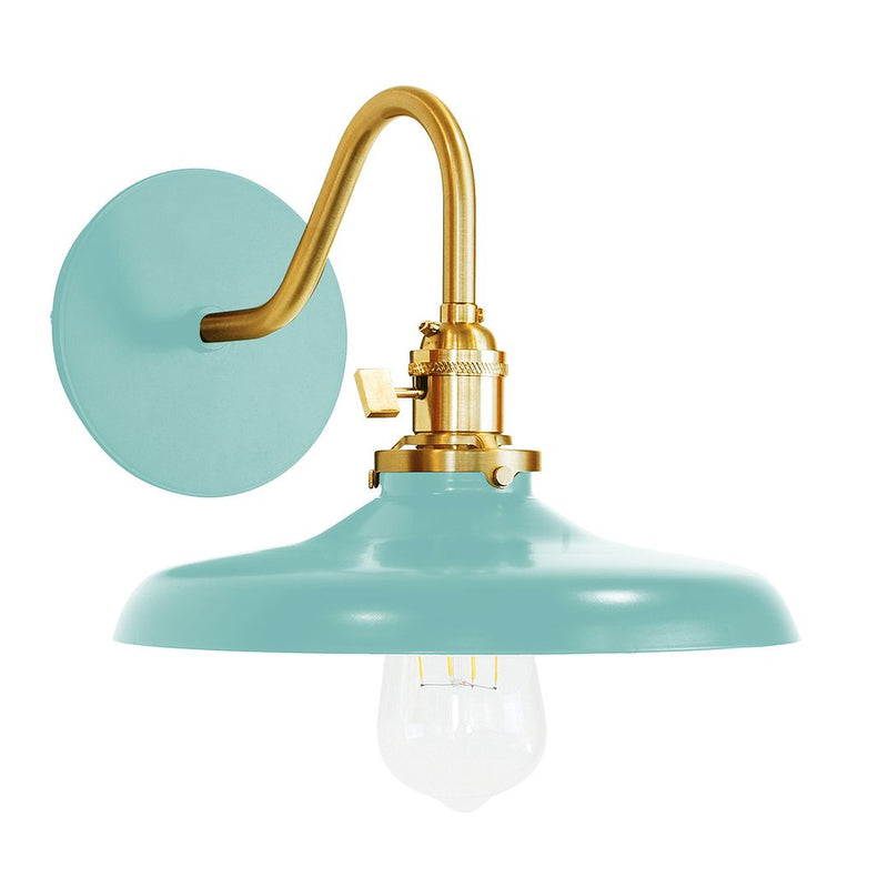Sea green wall sconce with brushed brass arm, dome shade, and frosted bulb