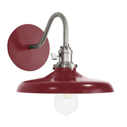 Barn red wall sconce with brushed nickel curved arm and downlight bulb
