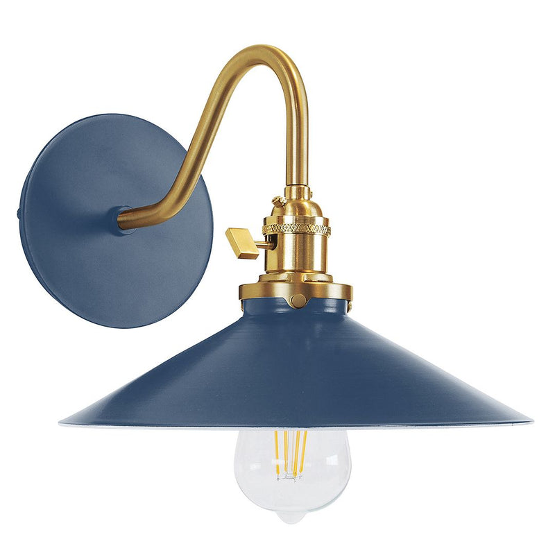Navy wall sconce with brushed brass arm and shade, featuring a clear globe bulb