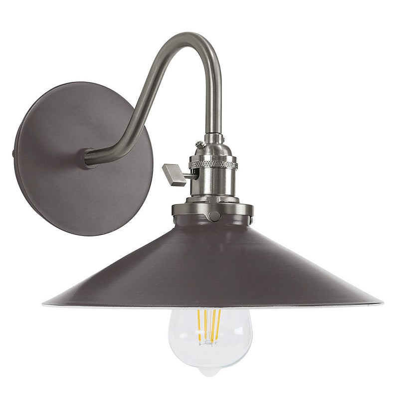 Bronze wall sconce with round backplate, curved arm, bell shade, clear bulb