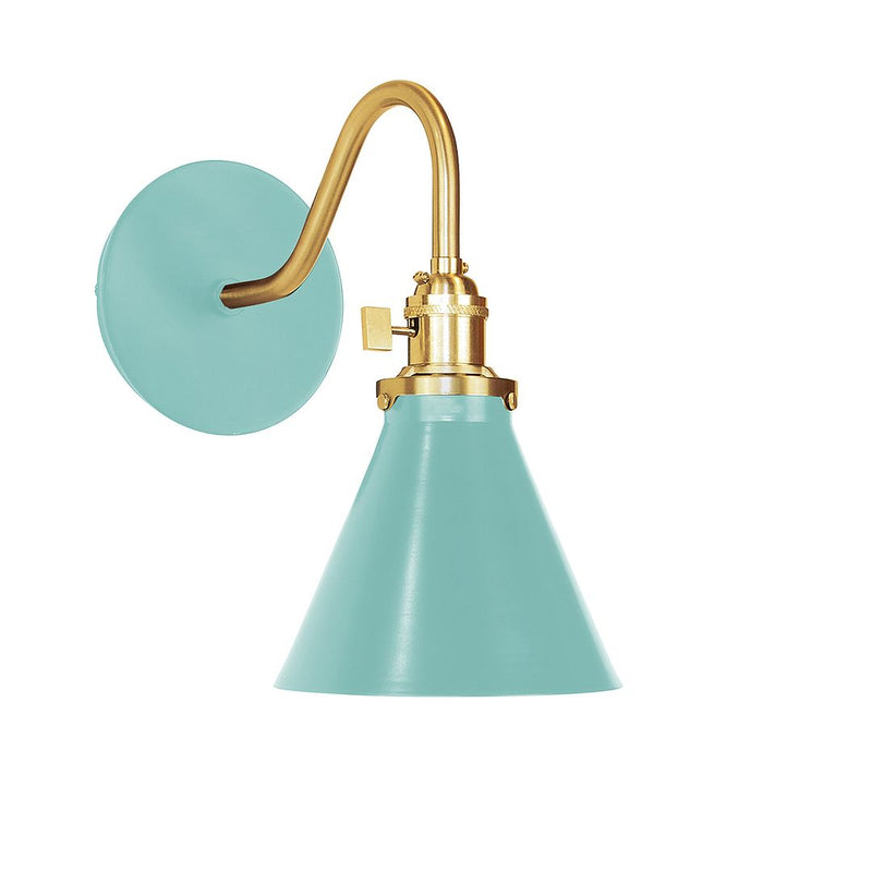 Sea green wall sconce with brushed brass arm, round backplate, and bell shade