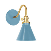 Light blue wall sconce with brushed brass curved arm and round backplate
