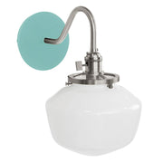 Sea green wall sconce with brushed nickel arm and white glass shade.