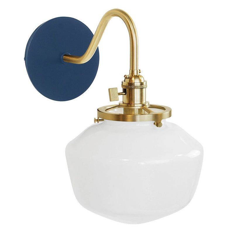 Navy wall sconce with brushed brass curved arm and clear white globe glass shade
