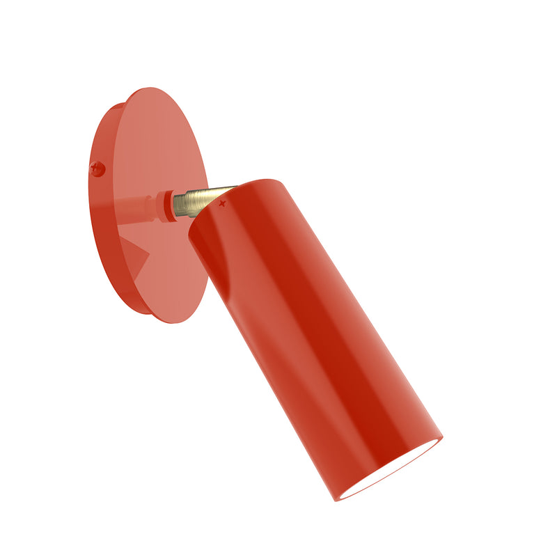 Wall sconce with vermillion cylindrical shade and adjustable arm, brushed brass accents