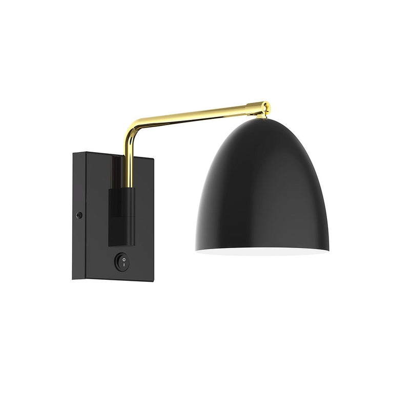 Black wall swing arm light with brushed brass arm and black dome shade.